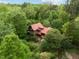 A lush green forest canopy surrounds a home with a distinctive red roof at 2917 Ericka Dr, Hillsborough, NC 27278