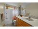 Bathroom with white tub and shower combination, wooden cabinets, and granite countertops at 2917 Ericka Dr, Hillsborough, NC 27278