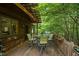 Inviting deck with outdoor seating and dining area amidst a peaceful wooded setting at 2917 Ericka Dr, Hillsborough, NC 27278
