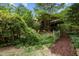 Wooded home with path and garden area, exuding rustic charm and natural beauty at 2917 Ericka Dr, Hillsborough, NC 27278