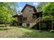 Wood-sided home with back porch, stairs, and mature trees offers a secluded feel at 2917 Ericka Dr, Hillsborough, NC 27278
