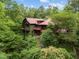 A charming multi-story residence in a wooded setting, complete with a red roof and inviting front porch at 2917 Ericka Dr, Hillsborough, NC 27278