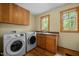Convenient laundry room with modern washer and dryer, plenty of cabinet and counter space at 2917 Ericka Dr, Hillsborough, NC 27278