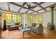 Comfortable living room with wood-beamed ceiling and large windows offering serene views at 2917 Ericka Dr, Hillsborough, NC 27278