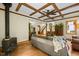 Inviting living room showcasing a wood-burning stove and eye-catching ceiling with exposed wooden beams at 2917 Ericka Dr, Hillsborough, NC 27278