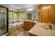 Luxurious main bathroom with a soaking tub, dual vanity, and a glass-enclosed shower at 2917 Ericka Dr, Hillsborough, NC 27278