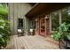 Charming porch with rocking chairs and a vibrant red door, creating a welcoming entrance at 2917 Ericka Dr, Hillsborough, NC 27278