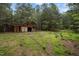 Exterior shot of a barn on a vast green field in a wooded area at 2917 Ericka Dr, Hillsborough, NC 27278