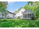 Rear exterior of home with screened in porch overlooking the large, lush backyard at 304 Parkridge Dr, Clayton, NC 27527