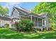 Home backyard features a large, screened-in porch overlooking the well-maintained lawn at 304 Parkridge Dr, Clayton, NC 27527