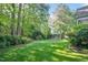 Backyard features lush lawn and mature landscaping for privacy and beauty at 304 Parkridge Dr, Clayton, NC 27527