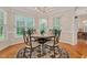 Bright dining area with round table set, chandelier, and three windows providing natural light at 304 Parkridge Dr, Clayton, NC 27527