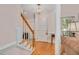 Welcoming foyer with hardwood floors, elegant staircase, and stylish lighting fixture at 304 Parkridge Dr, Clayton, NC 27527