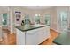 Well-lit kitchen island with a sink, white cabinetry, and a view into the breakfast nook at 304 Parkridge Dr, Clayton, NC 27527
