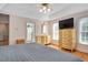 Bedroom featuring hardwood floors, a ceiling fan, and a door leading to the main bathroom at 304 Parkridge Dr, Clayton, NC 27527