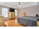 Bedroom featuring hardwood floors, a ceiling fan, and built in storage for optimal organization at 304 Parkridge Dr, Clayton, NC 27527