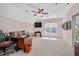Spacious office area with large desk, ceiling fan, and view of the yard at 304 Parkridge Dr, Clayton, NC 27527
