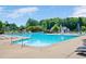 Community swimming pool with lounge chairs and umbrellas at 304 Parkridge Dr, Clayton, NC 27527