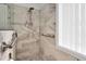 Close up of the shower featuring gray and white tile with shower head and grab bar at 304 Parkridge Dr, Clayton, NC 27527