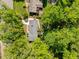 Aerial view of the house showcasing its mature trees and landscaped surroundings at 305 Clarendon Cres, Raleigh, NC 27610