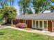 View of the house from the backyard featuring a patio and well-manicured lawn at 305 Clarendon Cres, Raleigh, NC 27610