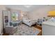 Charming bedroom with hardwood floors and natural light features neutral walls and bright trim at 305 Clarendon Cres, Raleigh, NC 27610