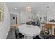 Open-concept dining area with a white table and black chairs near the kitchen at 305 Clarendon Cres, Raleigh, NC 27610