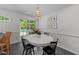 Cozy dining area with a white table, black chairs, and a modern pendant light at 305 Clarendon Cres, Raleigh, NC 27610