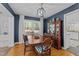 Inviting dining room featuring dark blue walls, a wooden table, and a vintage cabinet at 305 Clarendon Cres, Raleigh, NC 27610