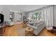 Bright living room with hardwood floors, comfortable seating, and large windows for natural light at 305 Clarendon Cres, Raleigh, NC 27610