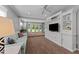 Spacious living room features built-in shelving, large windows, and a comfortable seating area at 305 Clarendon Cres, Raleigh, NC 27610