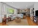 Inviting living room features a stone fireplace, hardwood floors, and a large window with natural light at 305 Clarendon Cres, Raleigh, NC 27610