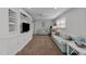Comfortable living room features a large built-in unit with a TV, seating, and natural light at 305 Clarendon Cres, Raleigh, NC 27610
