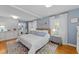 Cozy bedroom with hardwood floors and natural light features neutral walls and bright trim at 305 Clarendon Cres, Raleigh, NC 27610