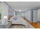 Cozy bedroom with hardwood floors and natural light features neutral walls and bright trim at 305 Clarendon Cres, Raleigh, NC 27610