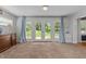 Sun-filled room with french doors leading to the backyard and neutral walls and trim at 305 Clarendon Cres, Raleigh, NC 27610