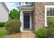 Close-up of the home's entrance, with a stone facade and manicured bushes at 3148 Rapid Falls Rd, Cary, NC 27519