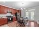 Eat-in kitchen features cherry wood cabinets, stainless steel appliances, and a view to the patio at 3148 Rapid Falls Rd, Cary, NC 27519