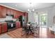 Bright eat-in kitchen features warm wood cabinetry, modern appliances, and access to a private outdoor patio at 3148 Rapid Falls Rd, Cary, NC 27519