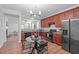 An inviting kitchen featuring wood cabinets, stainless steel appliances, and a stylish round dining table set at 3148 Rapid Falls Rd, Cary, NC 27519