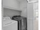 Convenient laundry room with modern washer and dryer, built-in shelving and a view to the main bedroom at 3148 Rapid Falls Rd, Cary, NC 27519