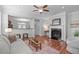 Open-concept living room with a fireplace, and view of the kitchen at 3148 Rapid Falls Rd, Cary, NC 27519