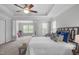 Bright, spacious main bedroom with tray ceilings and defined seating area, and a luxury, comfortable queen sized bed at 3148 Rapid Falls Rd, Cary, NC 27519