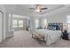 Spacious main bedroom featuring large windows, a tray ceiling, and a seating area at 3148 Rapid Falls Rd, Cary, NC 27519