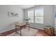 Charming office space with wood desk, soft rug, and bright natural light from a large window at 3148 Rapid Falls Rd, Cary, NC 27519