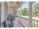 Cozy screened porch with comfortable seating, string lights, and views of the landscaped backyard at 3148 Rapid Falls Rd, Cary, NC 27519