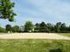 Well-kept community sand volleyball court with a grassy surround and blue skies at 3148 Rapid Falls Rd, Cary, NC 27519