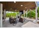 Inviting covered back porch with a seating area, ceiling fan, and outdoor television for entertainment at 3215 Bellamy Ridge Dr, Apex, NC 27523