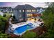 Stunning backyard with a luxurious pool, spa, and outdoor living area with a covered deck at 3215 Bellamy Ridge Dr, Apex, NC 27523