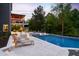 Luxurious backyard with pool, hot tub, sun loungers, and covered patio; perfect for entertaining at 3215 Bellamy Ridge Dr, Apex, NC 27523